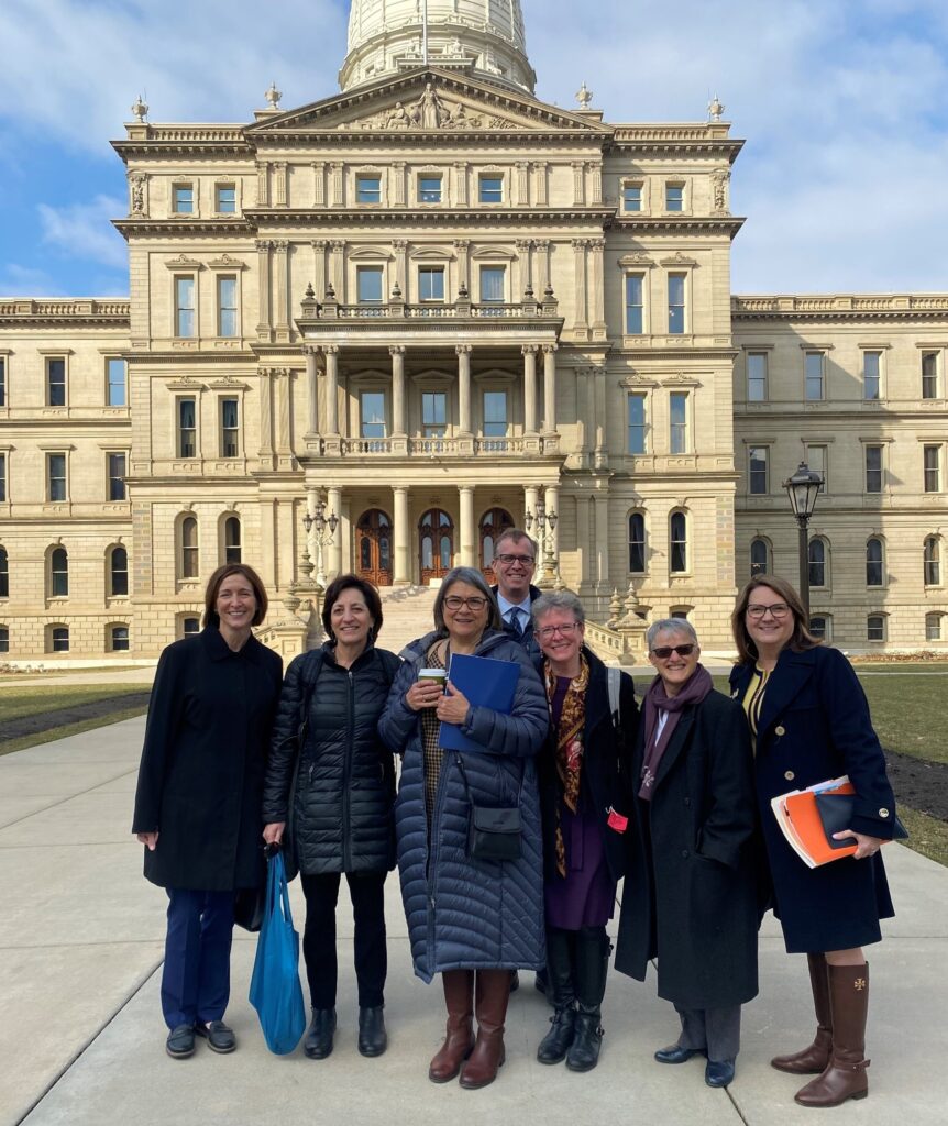 MC3 leaders and advocates standing in front of the capitol building in Lansing, Michigan