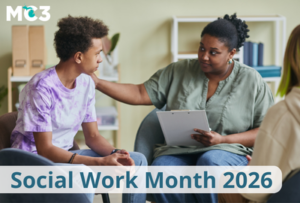 Social worker sitting in a chair comforting a teen boy sitting next to her.