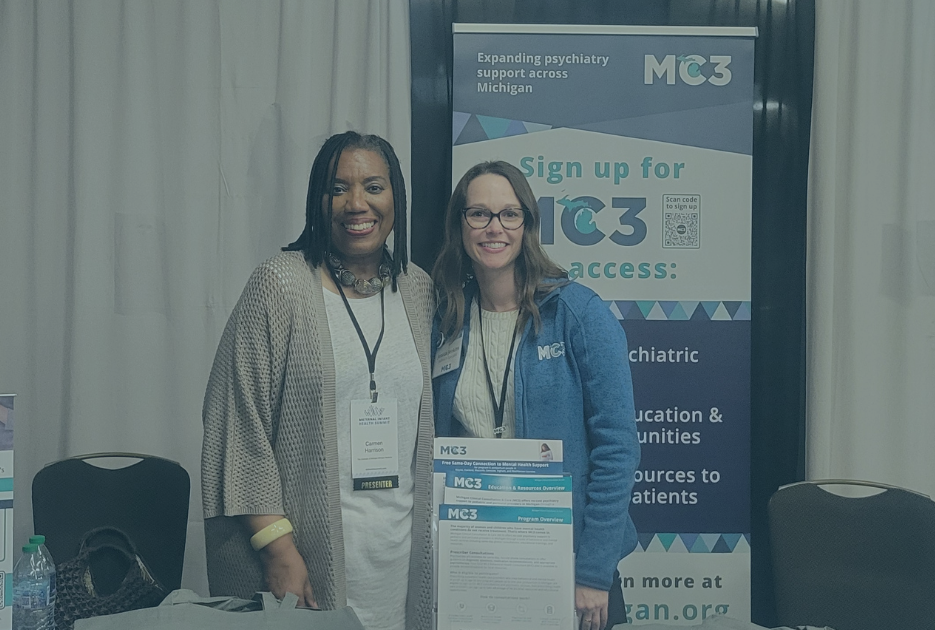 Two MC3 outreach team members present at an event.