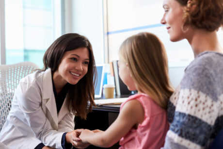 Doctor meeting with a parent and her child.